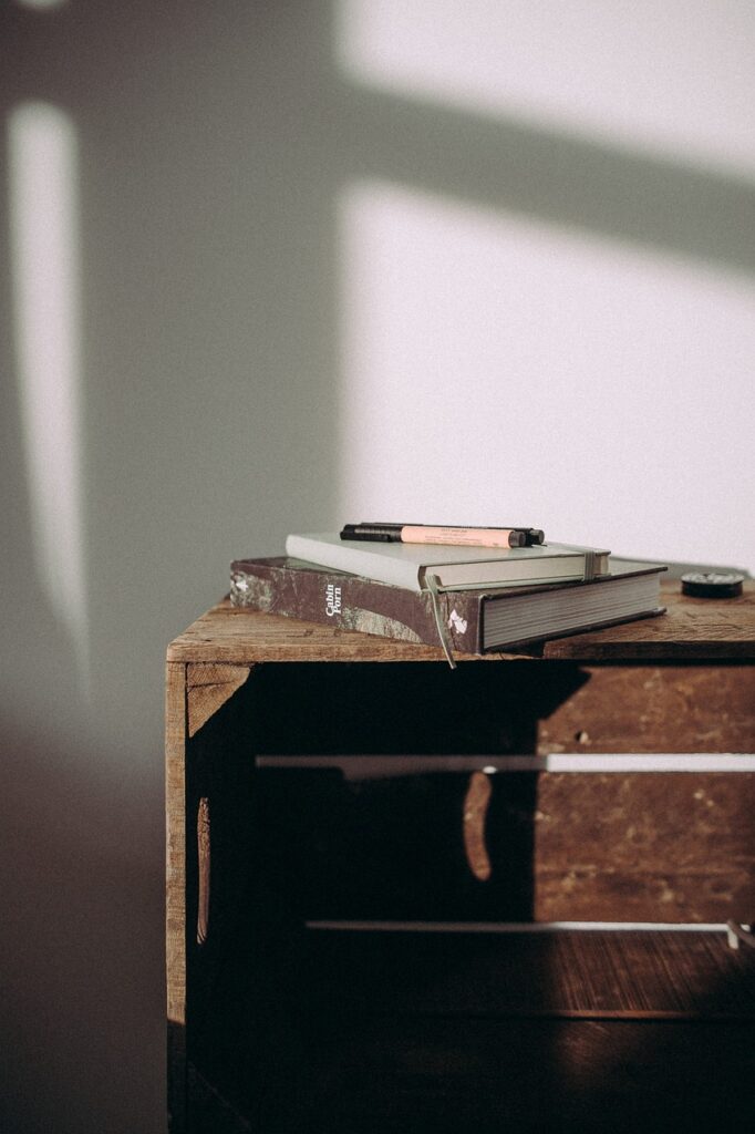 wooden, table, books, notebook, pens, sunlight, wall, shadow, journal