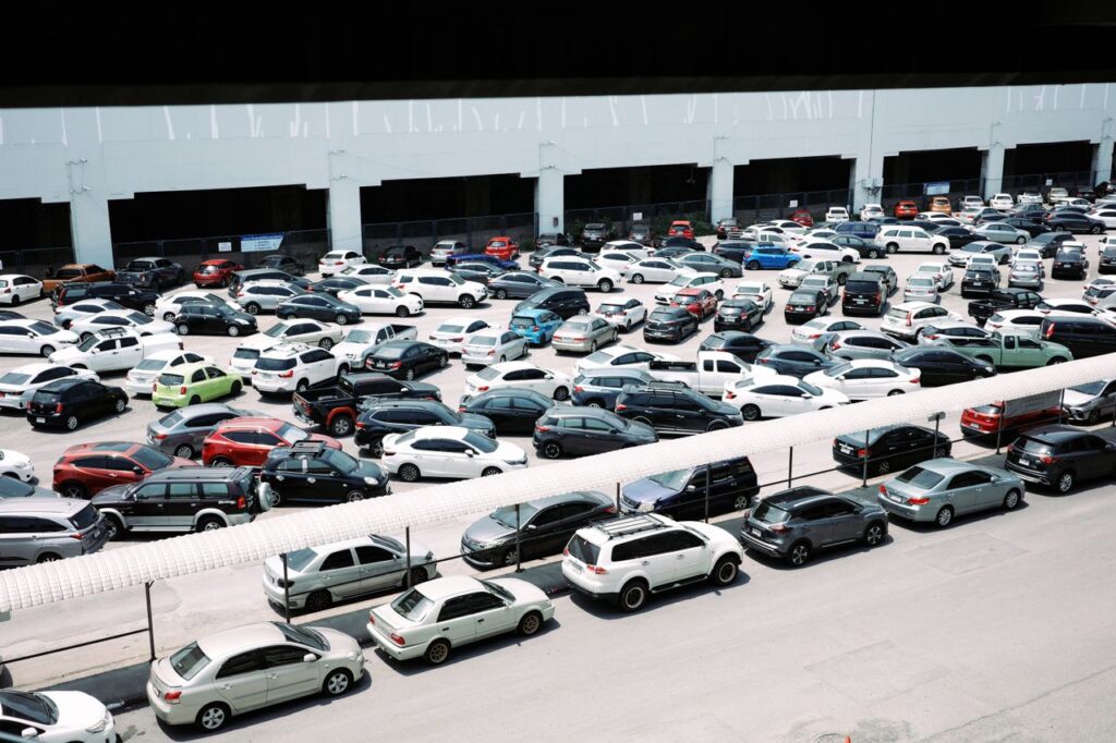 High-angle view of a crowded urban parking lot filled with various parked cars.