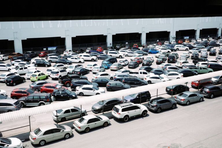 High-angle view of a crowded urban parking lot filled with various parked cars.