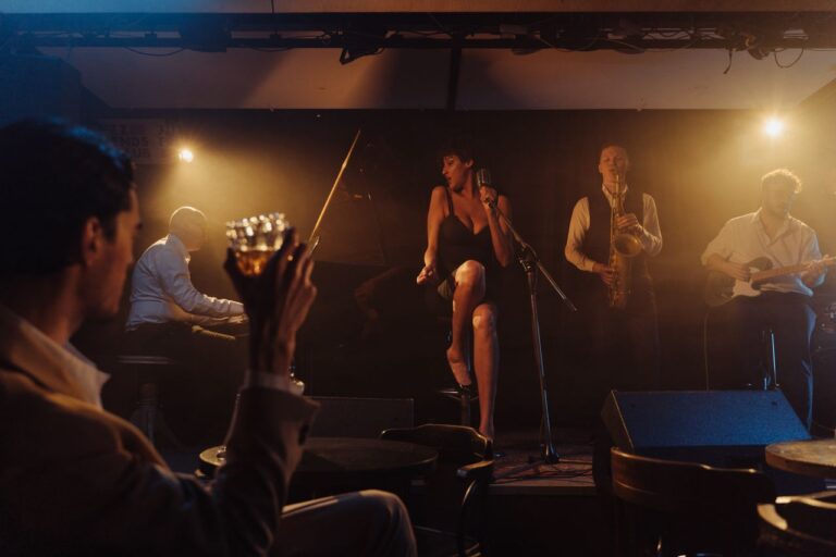 A vibrant jazz band performing live on stage with a singer in a cozy bar ambiance.